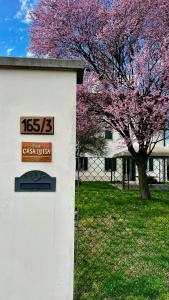 a sign on the side of a building with a tree at Casa Luisa in Lesignana