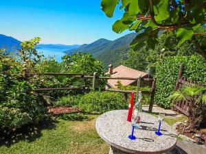 a table with two wine glasses on top of it at Casa ai Ghiri in Cannero Riviera