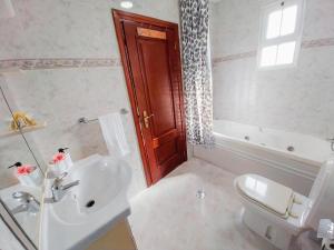 a bathroom with a sink and a toilet and a tub at Amazing View in Gaula +4 photos
