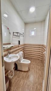 a bathroom with a sink and a toilet at Ami House Da Lat in Da Lat +10 photos