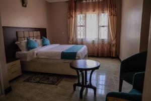 Ліжко або ліжка в номері Benru Suites Hotel