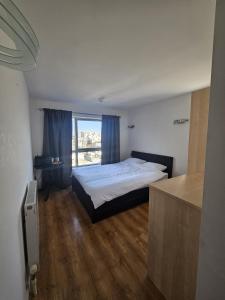 a bedroom with a bed and a large window at En-suite room LGBTQ friendly in London