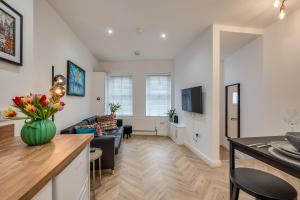 a living room with a couch and a table at Stylish 2 Bedroom Apartment in Belfast in Belfast