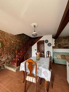 a dining room with a table and a couch at Casa Martorell Ferrol in Ferrol