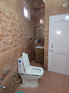 a bathroom with a toilet and a sink at Whispering in Shogi +10 photos