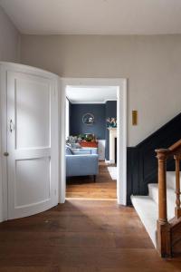 a hallway with a living room with a couch at Country Retreat - Sleeps 14 - Large Garden in Westbourne