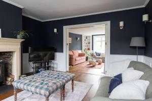 a living room with a couch and a fireplace at Country Retreat - Sleeps 14 - Large Garden in Westbourne +58 photos