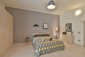 a bedroom with a bed and a television in it at Tasso Apartment in Salerno