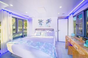 a bedroom with a large bed and some windows at Unique Houseboat Rental in Merritt Island +49 photos