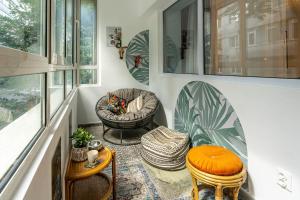 a living room with two chairs and a couch at Eclectic Condo Romexpo 2BR near Metro in Bucharest