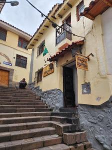 a building with stairs in front of a building at Amankay Inn in Cusco