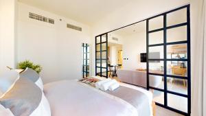 a bedroom with a white bed and a large window at The Community Jumeirah Village in Dubai +121 photos
