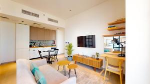 a living room with a couch and a table at The Community Jumeirah Village in Dubai