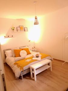 a bedroom with a large bed with orange pillows at Elunà Assisi Home in Assisi