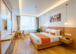 A bed or beds in a room at Hotel Anuttara