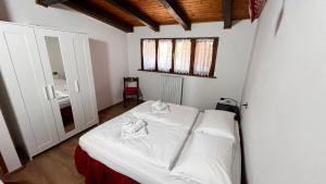 Postel nebo postele na pokoji v ubytování Silvydolomitiapartment