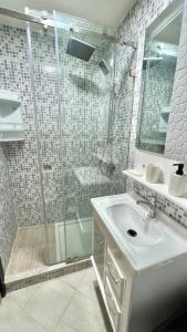 a bathroom with a shower and a sink at T6 Luxury in Témara Discover a Comfortable Apartment in Temara