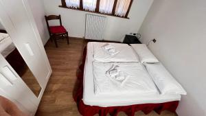 Postel nebo postele na pokoji v ubytování Silvydolomitiapartment