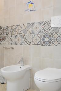 a bathroom with a toilet and a sink at Scaglione Palace in Gallipoli +23 photos