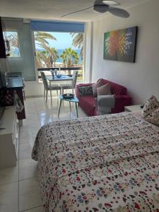 a bedroom with a bed and a living room at Nice Studio Apartment with Ocean View in Arguineguín