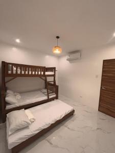 a bedroom with two bunk beds and a light at Villa Serene Resort in General Trias +18 photos