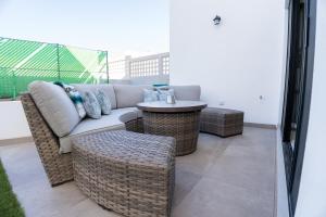 a patio with a couch and chairs and a table at Cabo San Lucas House, 2Bedroom, 2Bathrooms,Pool, Rooftop views in El Pueblito