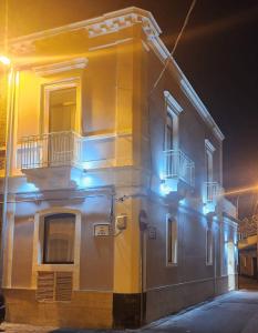 a building with blue lights on the side of it at Palazzo Grecale Dell'Etna in Aci SantʼAntonio