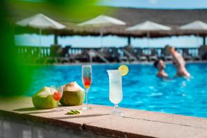 two glasses of wine and melons next to a swimming pool at Marriott Cancun, An All-Inclusive Resort in Cancún