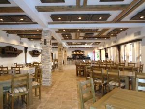 a dining room with wooden tables and chairs at Комплекс Стара Плиска in Pliska