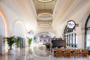 a lobby of a mall with a table and chairs at Marriott Cancun, An All-Inclusive Resort in Cancún