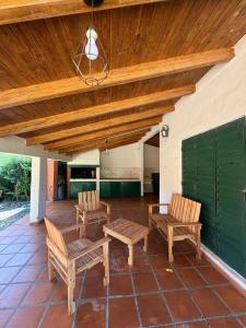 eine Terrasse mit zwei Stühlen und einer Holzdecke in der Unterkunft Quinta Trento in Villa María