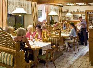 a group of people sitting at tables in a restaurant at Landgasthof Zur schönen Wienerin in Marbach an der Donau