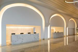 an empty lobby with two reception desks in a building at Marriott Cancun, An All-Inclusive Resort in Cancún +167 photos