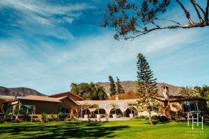 a house with a large yard with a tree at Hacienda Huamalata in Ovalle
