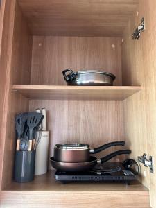 a pot and pans sitting on a stove in a kitchen at Charming condo 5min walk to MRT near DMK,Chatuchak in Bangkok