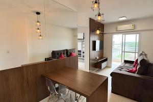 a living room with a table and a couch at Apartamento em Bertioga - SP (2) in Ilha Monte Pascoal