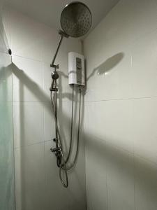 a shower in a bathroom with a shower head at Charming condo 5min walk to MRT near DMK,Chatuchak in Bangkok
