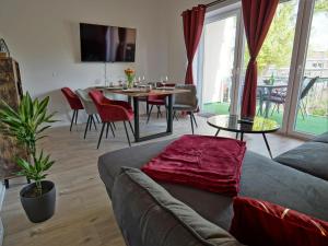 a living room with a couch and a table at HOGULU - 3 - RAUM - App 25 mit Balkon in Brandenburg an der Havel