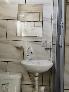 a bathroom with a sink and a toilet at Apartamento Cavalcante in Belém