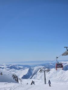 a group of people skiing on a ski lift at Chalet Gudauri in Gudauri