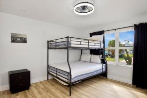 a bedroom with two bunk beds and a window at Anchors Away by Sun Palace Vacations in Fort Myers Beach +20 photos