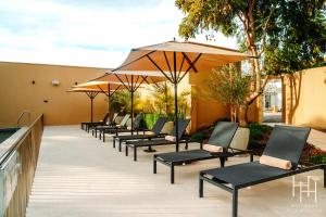 a row of chairs with umbrellas on a patio at Hacienda Huamalata in Ovalle
