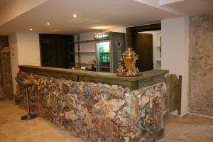 a bar with a stone wall in a room at Комплекс Стара Плиска in Pliska +19 photos