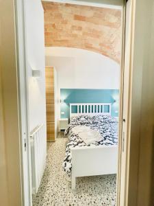 a bedroom with a white bed and a blue wall at Rome to You- Easy way Apartment in Rome