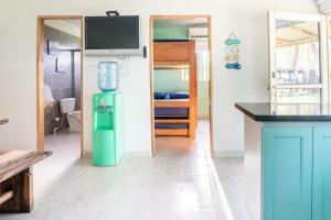 a kitchen with a green water cooler in a room at Cabaña Las Tres Palmas in San Bernardo del Viento in San Bernardo del Viento +49 photos