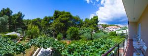a balcony with a view of a garden at Apartments Nicole in Pula