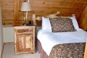 a bedroom with a bed and a table with a lamp at Beautiful Views Of Mt Quandary Off Private Balcony in Breckenridge