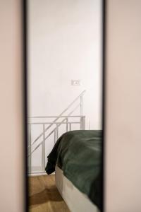 a bedroom with a bed and a stair case at Dimora Berardino in Triggiano +35 photos
