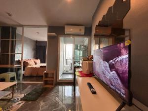 a living room with a large flat screen tv at Modern2 1BR at Bangson in Bangkok