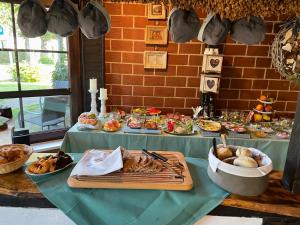 a table with many plates of food on it at Landhaus Schlunt in Wustrow
